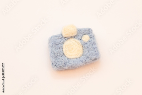 Felted blue camera on a white background. Felted toys. Handmade requisites
