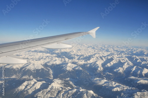 Airplane's wing during a flight over the Alps