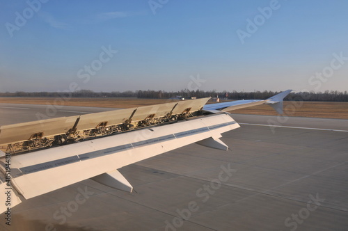 Airplane wing during plane landing at airport