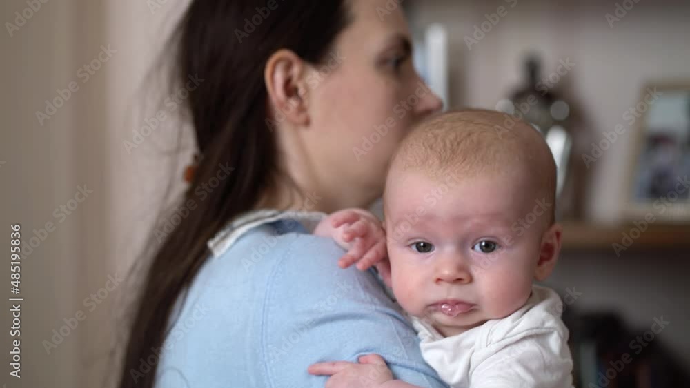 Young mother holding a newborn baby boy in her arms Young mother holding a newborn baby boy in her arms