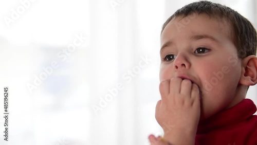 Close-up of a baby eating a juicy tangerine