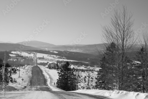 Road in a winter countryside landscape in the province of Quebec, Canada