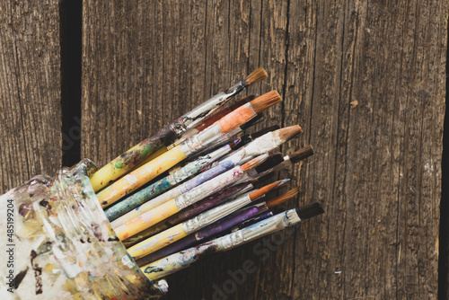 brushes in watercolor paint on an isolated background closeup ,hobby and creativity