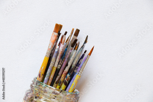 brushes in watercolor paint on an isolated background closeup ,hobby and creativity