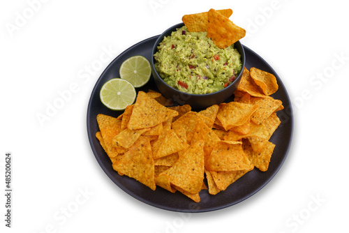 Top view of guacamole sauce and tortilla chips or nachos in black plate isolated on a white background