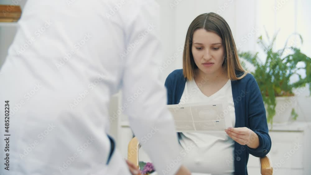4k video of sad pregnant woman talking with a doctor. 4k video of sad pregnant woman talking with a doctor.