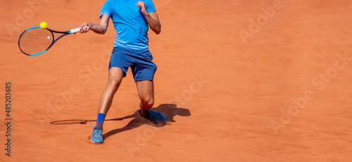 Male tennis player in action on the court on a sunny day. Horizontal sport theme poster, greeting cards, headers, website and app © Augustas Cetkauskas