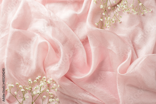 Top view photo of the big and nice branches of gypsophila on the pastel pink isolated and textile background blank space