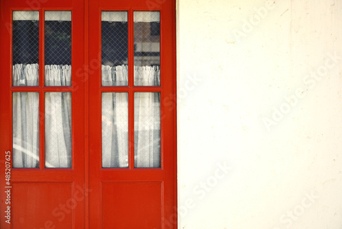 Antique red door and white exterior wall
