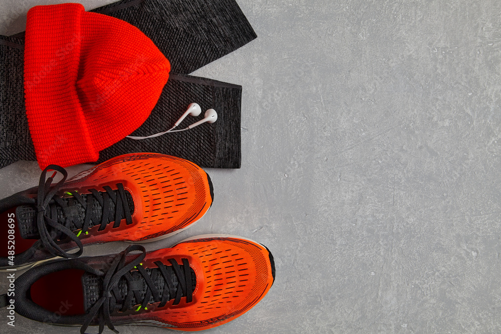 Orange running sneakers, orange knitted hat, warm leggings for sports