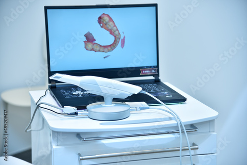 Dental intraoral 3d scanner and laptop on table