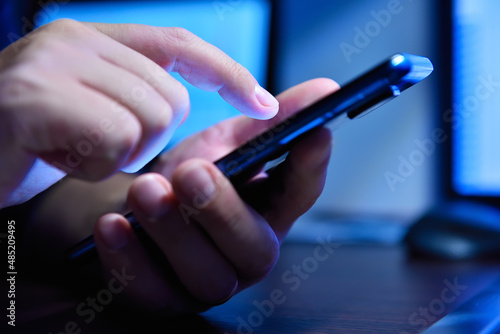 Businessman hands using smartphone in hight office.