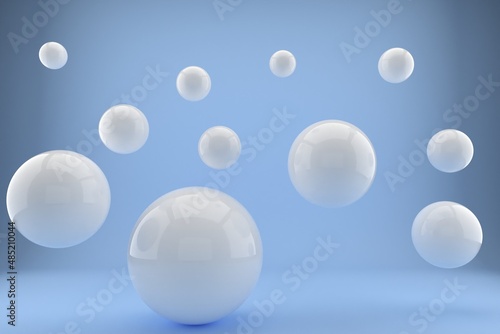 3d rendering of several sized reflected white spheres on blue background © Vic