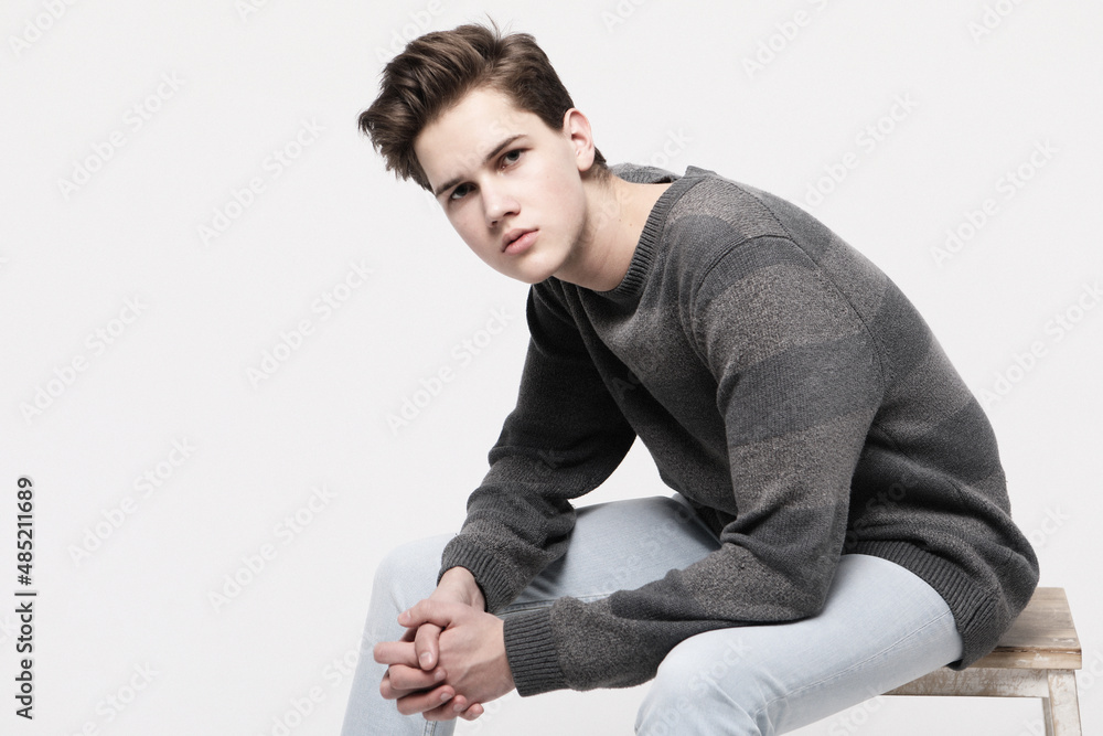 young handsome teenage hipster guy posing against white background isolated young handsome teenage hipster guy posing against white background isolated