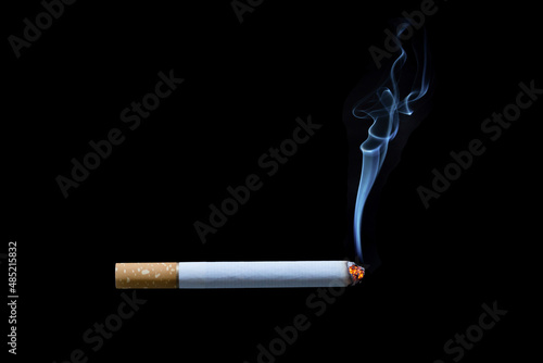 Cigarette with smoke on black background..