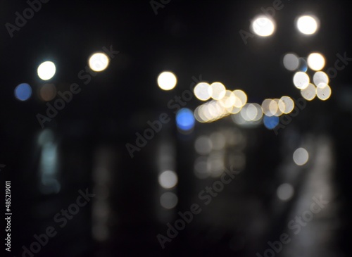 Abstraction. Alley of the night park in rainy weather. Bokeh. Blurry background. © m7_ir7