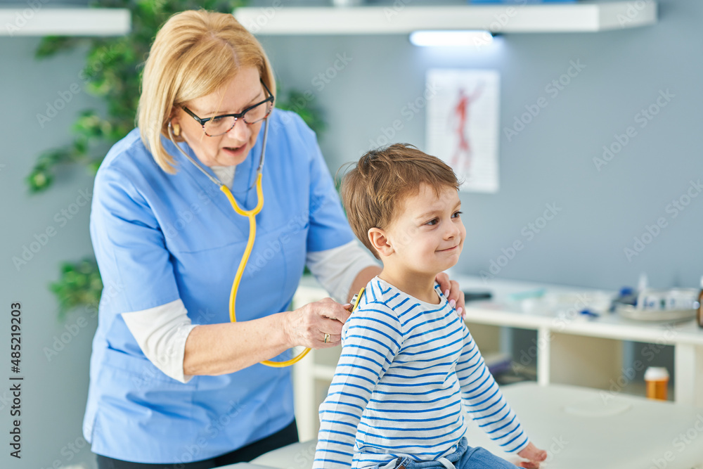 Pediatrician doctor examining little kids in clinic