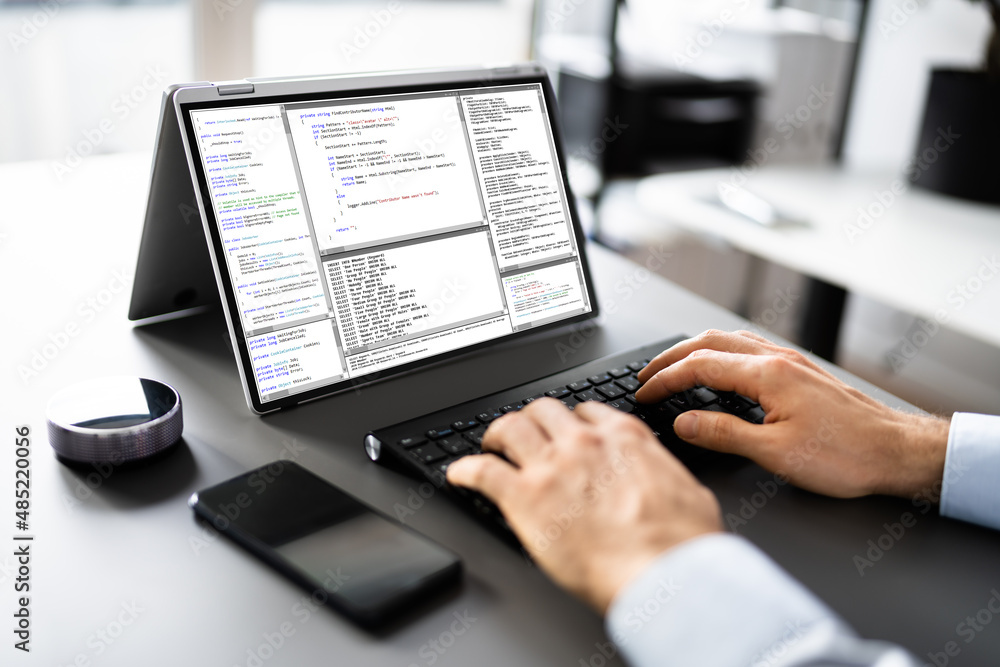 Computer Programmer Writing Program Code On Computer Computer Programmer Writing Program Code On Computer