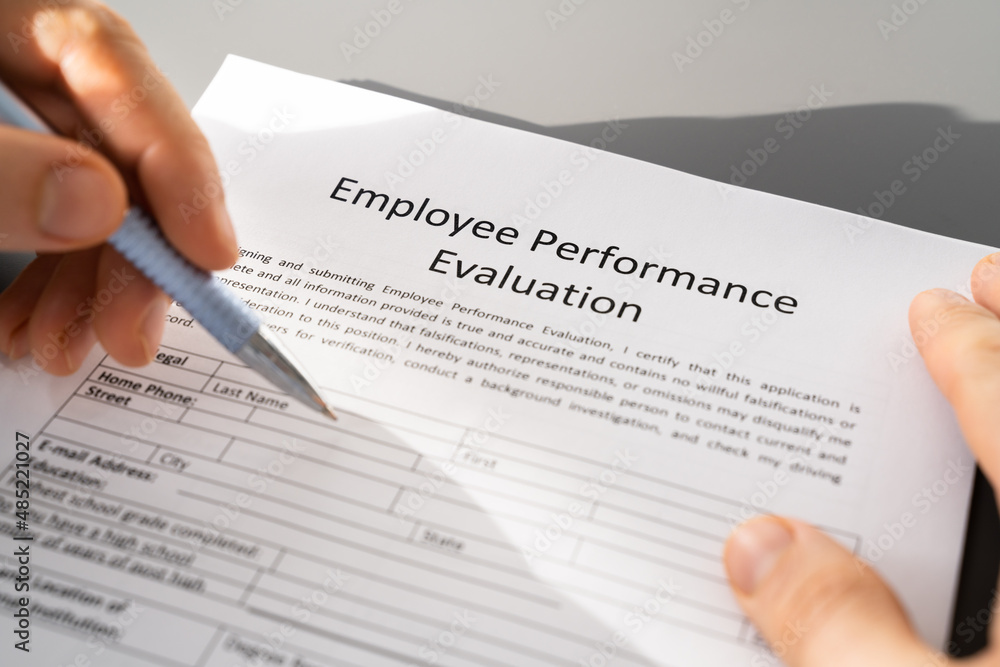 Person Filling A Performance Evaluation Form Person Filling A Performance Evaluation Form