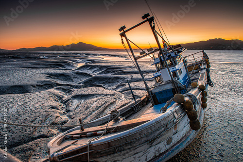Photos Scenery of fishing village and fishing boat at low tide
