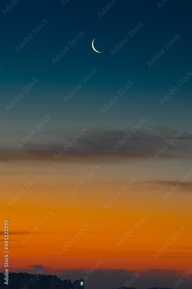 The crescent moon seen in the beautiful dawn The crescent moon seen in the beautiful dawn