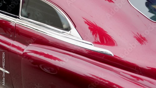 This video shows a rear view of a kustom chopped 1950 - 1951 Cadillac with a beautiful red paint job.