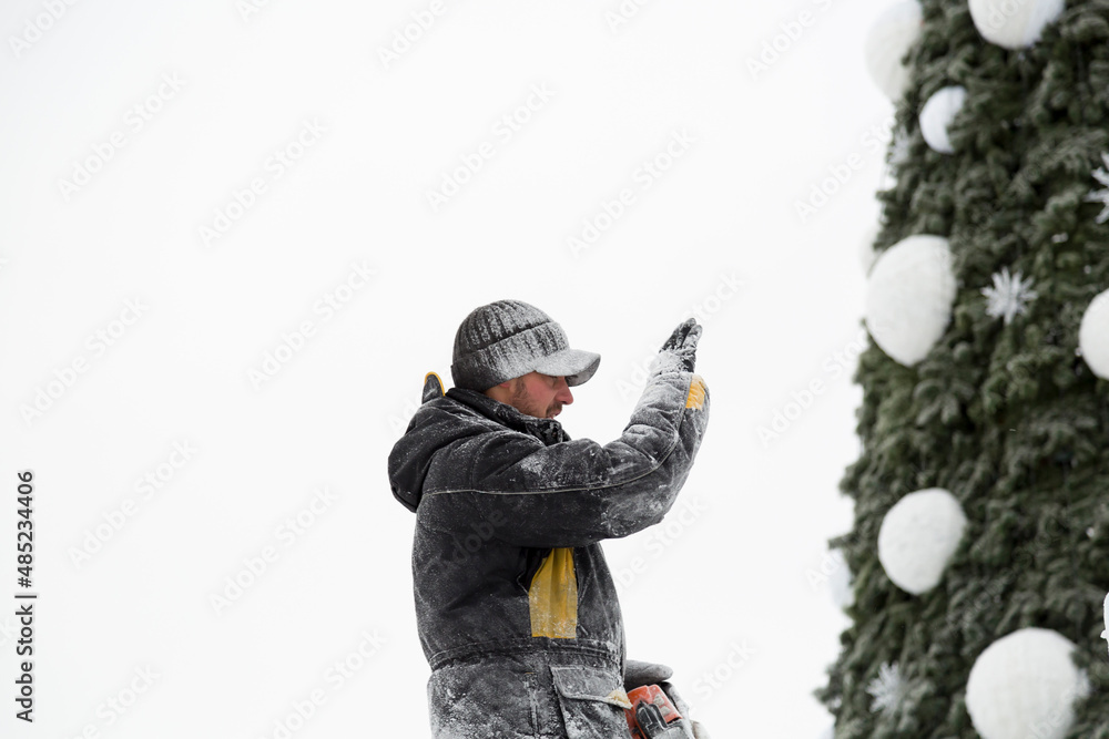 Portrait of a sculptor with a chainsaw at work Portrait of a sculptor with a chainsaw at work