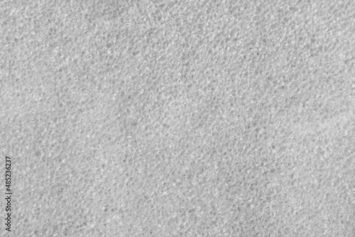 The texture of the surface of the white packaging foam in close-up.