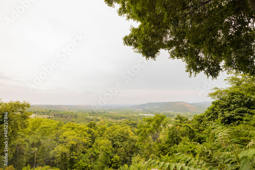 Beautiful green nature mountain landscape view on pale sky background. Greece.