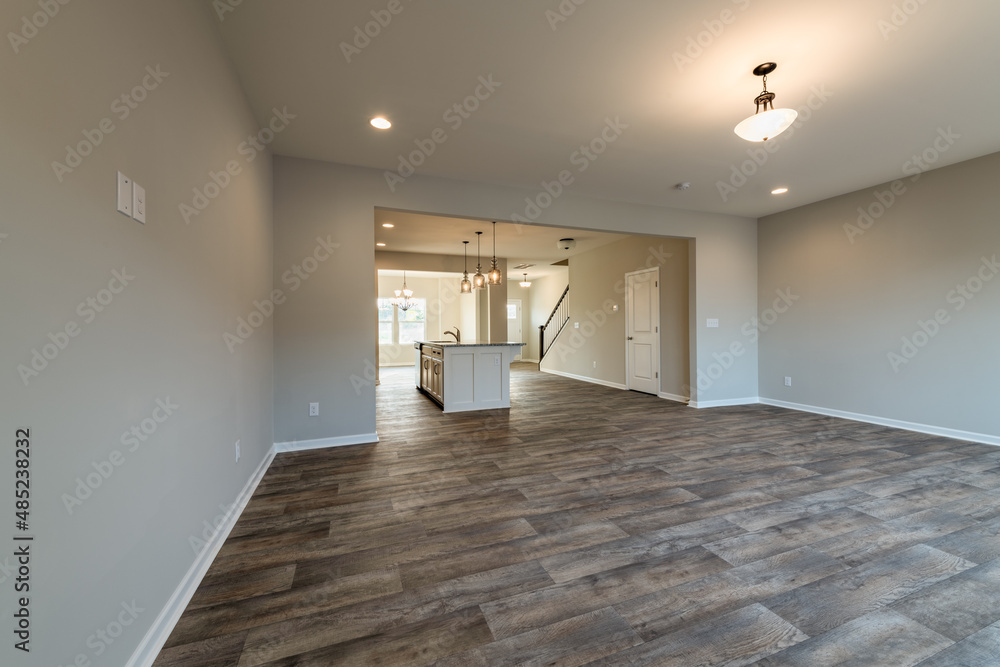 Empty modern townhouse floor showcasing a kitchen with living and dinning room ready to be moved in. Investment, renting, or house ownership concept. Empty modern townhouse floor showcasing a kitchen with living and dinning room ready to be moved in. Investment, renting, or house ownership concept.