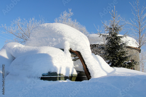 An old car covered in snow.