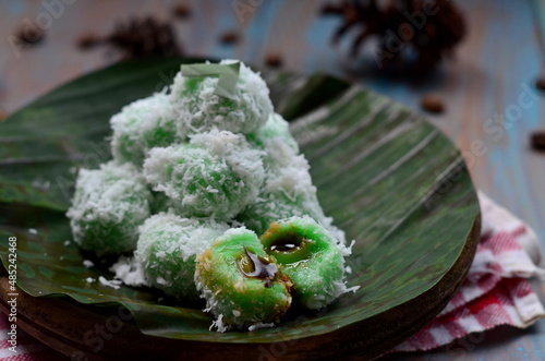 kelepon or klepon or onde-onde made from glutinous rice flour and filled with brownn sugar covered with grated coconut. Some people called this traditional cake from Indonesia as Onde-onde photo