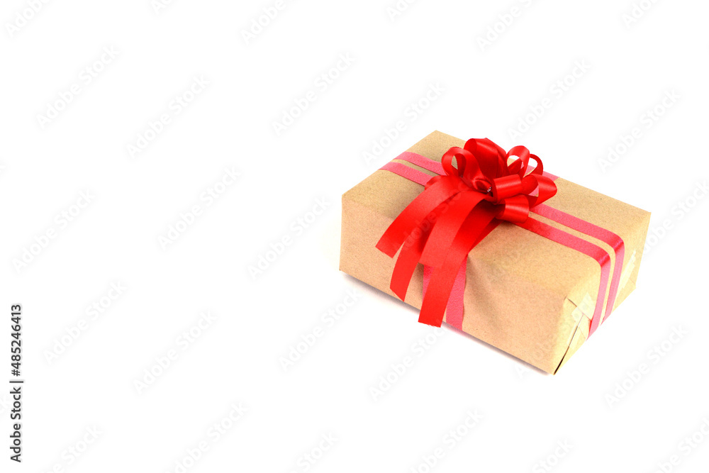 Brown craft gift box with red ribbon bow isolated on white background. Brown craft gift box with red ribbon bow isolated on white background.