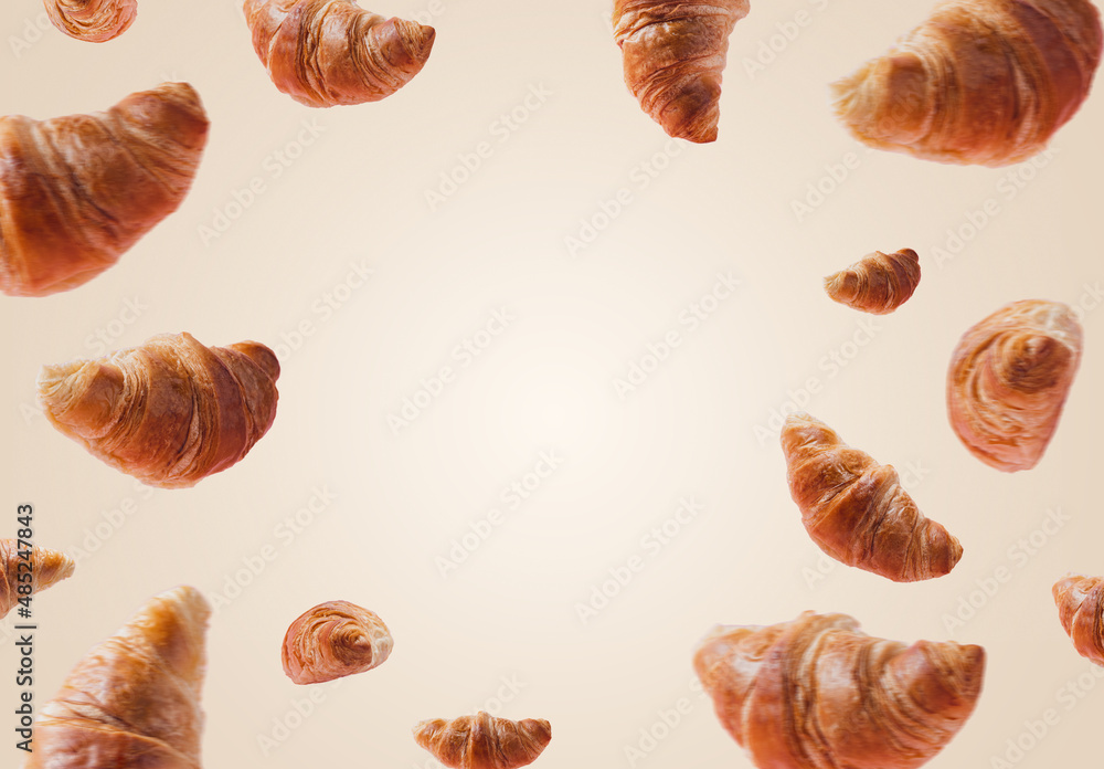 Freshly baked croissants levitating or flying. Set of many croissants from different position and angle fly in the air isolated on white beige background. Copy space place for text. Signboard mockup