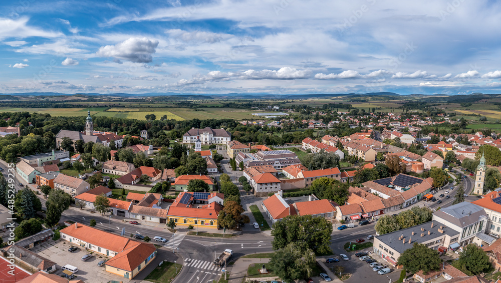 Aerial view of historic Szecseny town on the Hungarian Slovakian border with traces of medieval city wall, towers and white wall Forgach castle