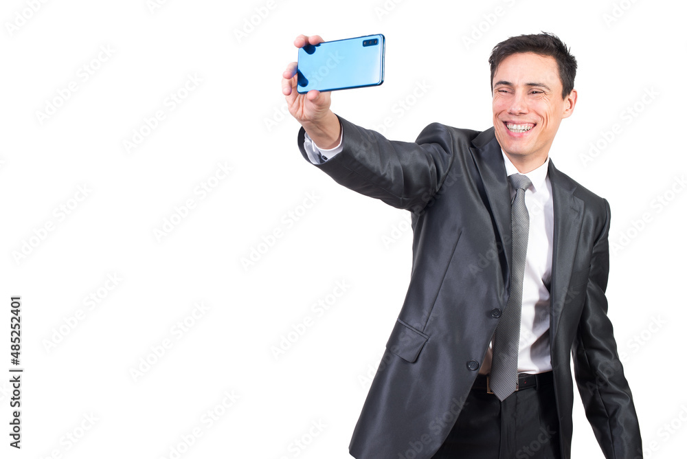 Cheerful man in suit taking selfie in studio