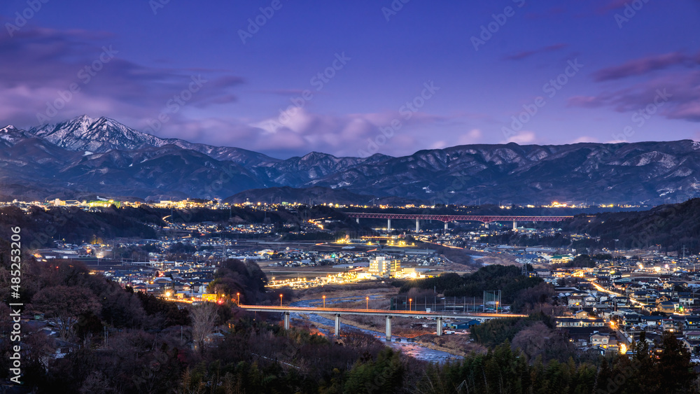 evening view of Japanese rural city and  mountains