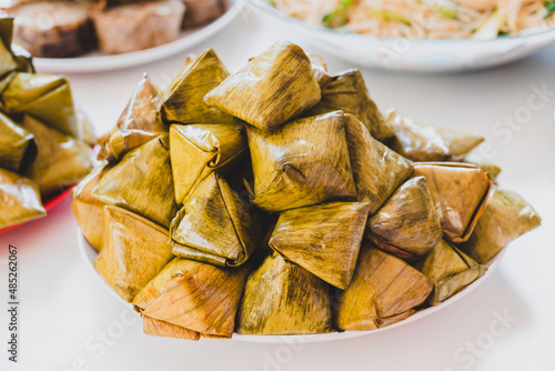 stuffed dough pyramid or dough wrapped in banana leaves for chinese new year celebrations. chinese new year food.