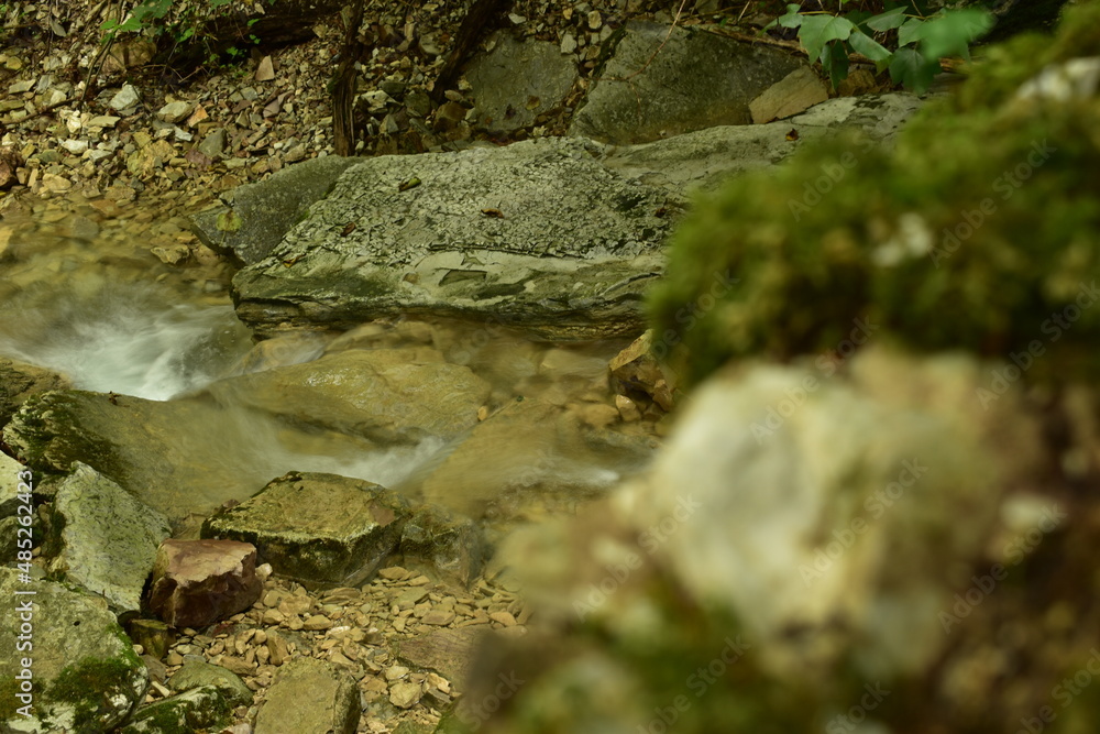 a clean mountain river flows over calcareous stones a clean mountain river flows over calcareous stones