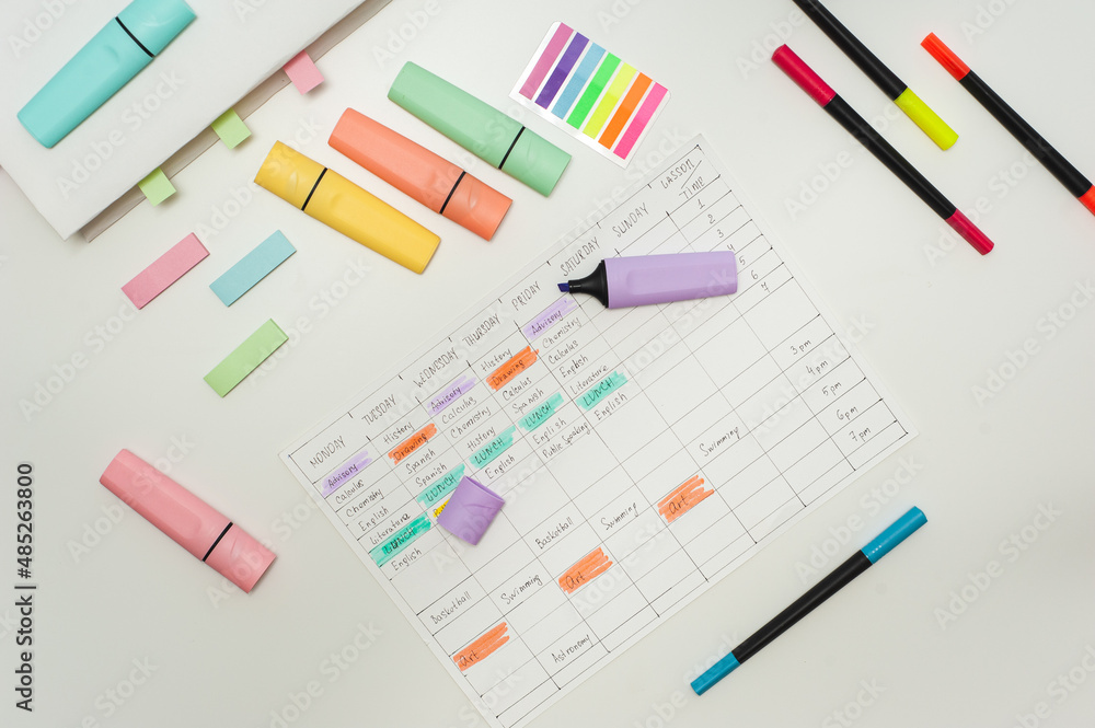 School schedule. A sheet with a handwritten school schedule lies on a white table strewn with colorful markers and stickers. School Time Management School schedule. A sheet with a handwritten school schedule lies on a white table strewn with colorful markers and stickers. School Time Management