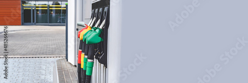 Long Banner, gas station with petrol and diesel hoses. Against the backdrop of a window. photo