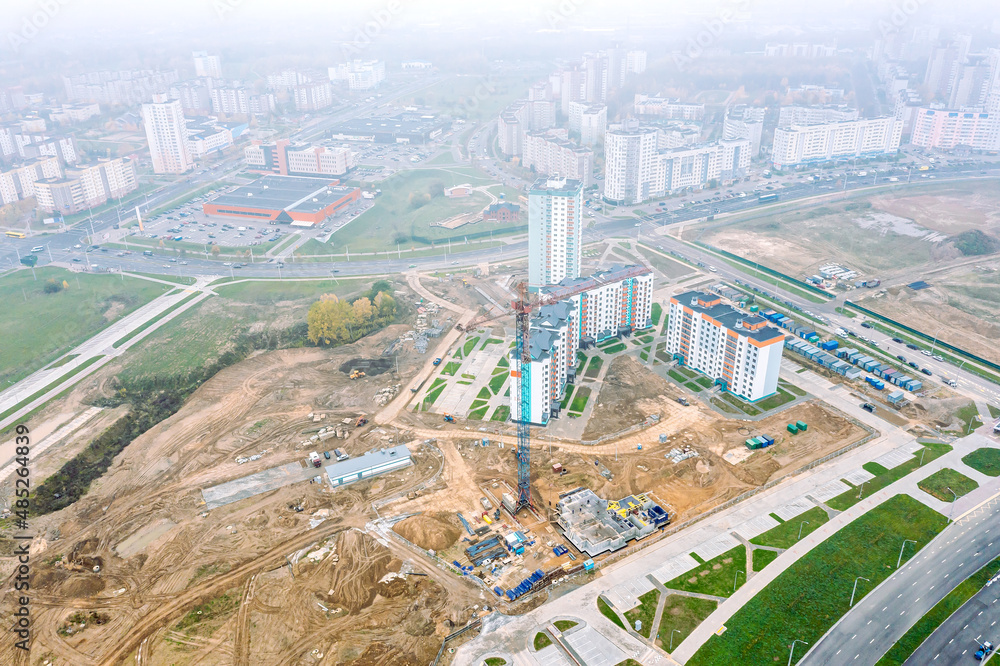 high-rise residential buildings under construction. captured from above with a drone in foggy day.