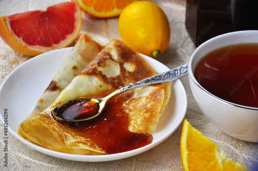 Pancakes on a plate with Citrus jam with orange and grapefruit Pancakes on a plate with Citrus jam with orange and grapefruit
