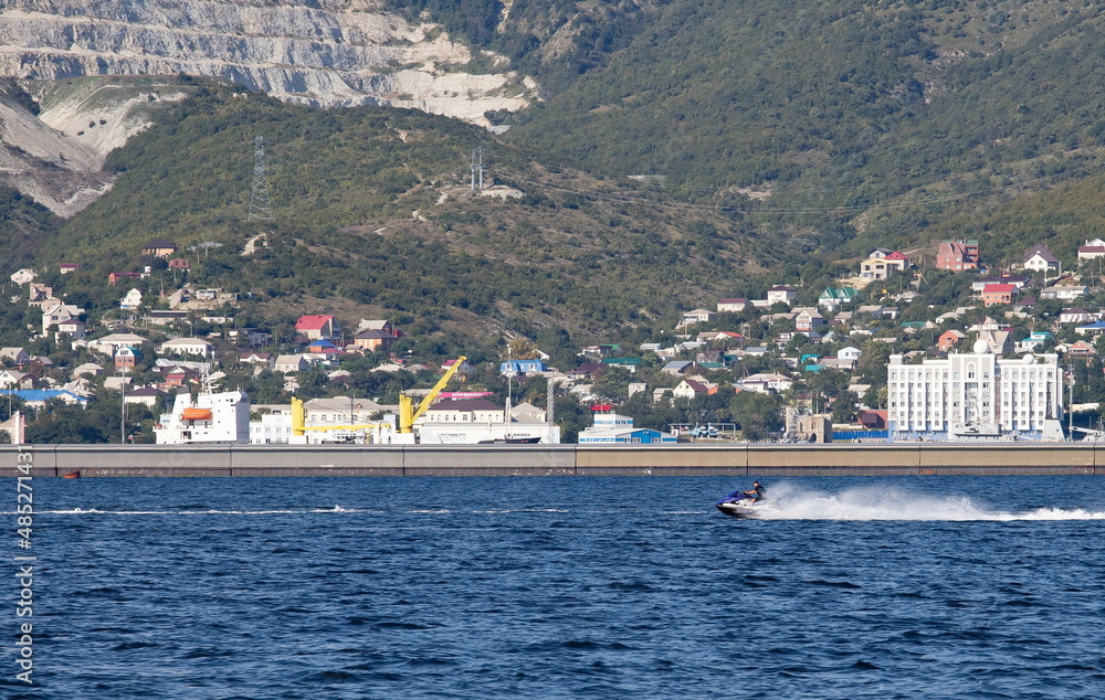 Beautiful water scooters on the background of the pier in the bay of the city of Novorossiysk in summer Beautiful water scooters on the background of the pier in the bay of the city of Novorossiysk in summer