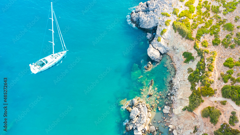 Waves and yacht from top view. Turquoise water background from top view. Summer seascape from air. Top view from drone. Travel-image