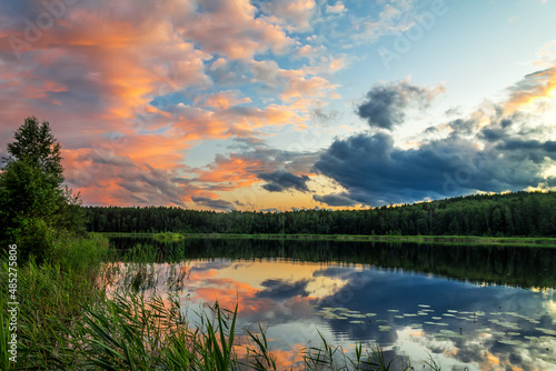 Fototapeta Naklejka Na Ścianę i Meble -  Beautiful sunset over lake with lonely tree