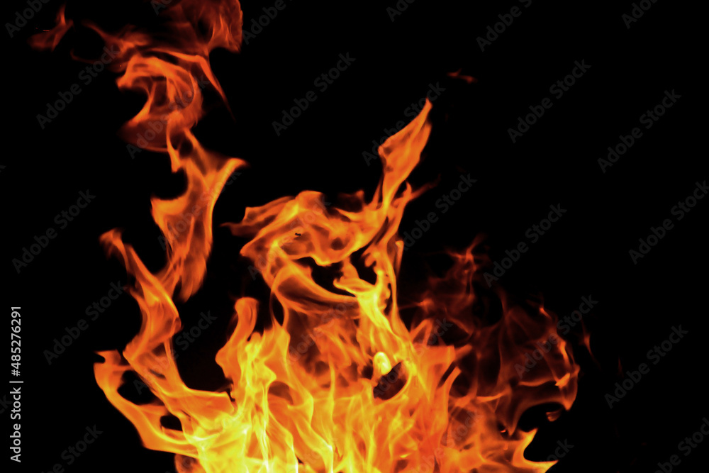 Close up burning flames on black background for graphic design or wallpaper Close up burning flames on black background for graphic design or wallpaper