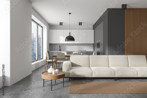 Dark kitchen room interior with sofa, coffee table, dining table