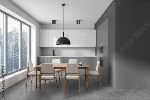 Dark kitchen room interior with double oven, dining table