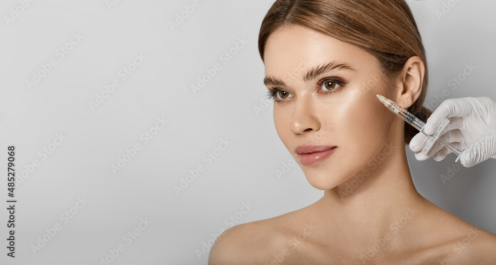Beauty injections into beautiful face. Smoothing of mimic wrinkles around eyes using beauty injections with fillers, procedure biorevitalization - obrazy, fototapety, plakaty 